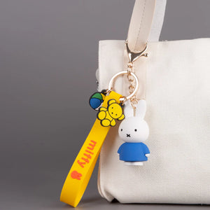 Keychain with MIffy bunny character attached to a white bag on a gray background