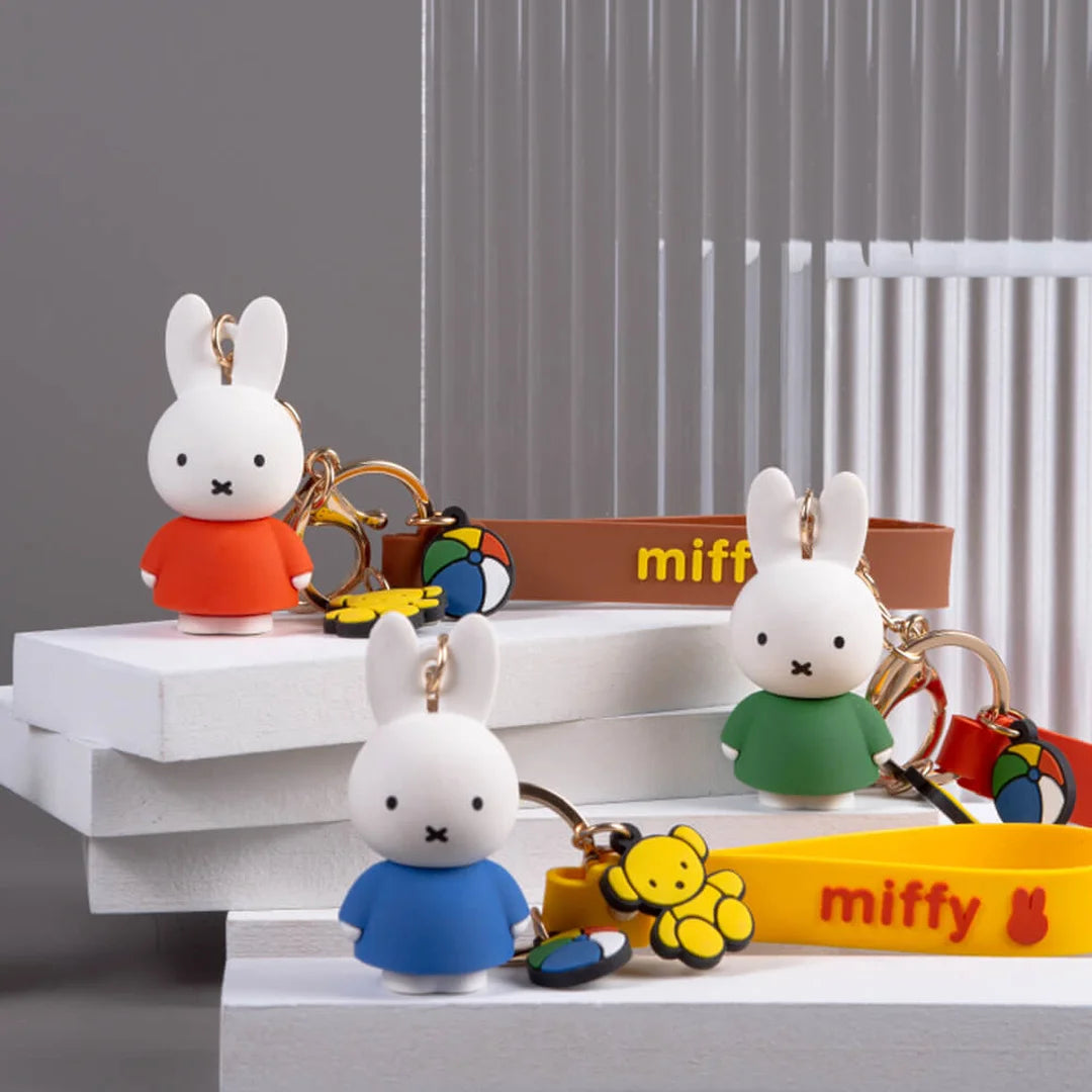 Miffy keychains on a white surface with 'miffy' branding.