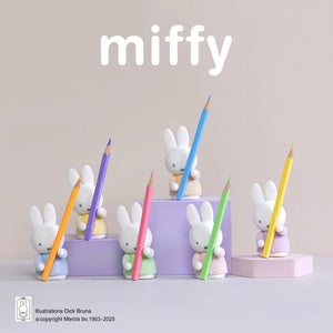 Miffy pencil holders with colorful pencils on a light gray background