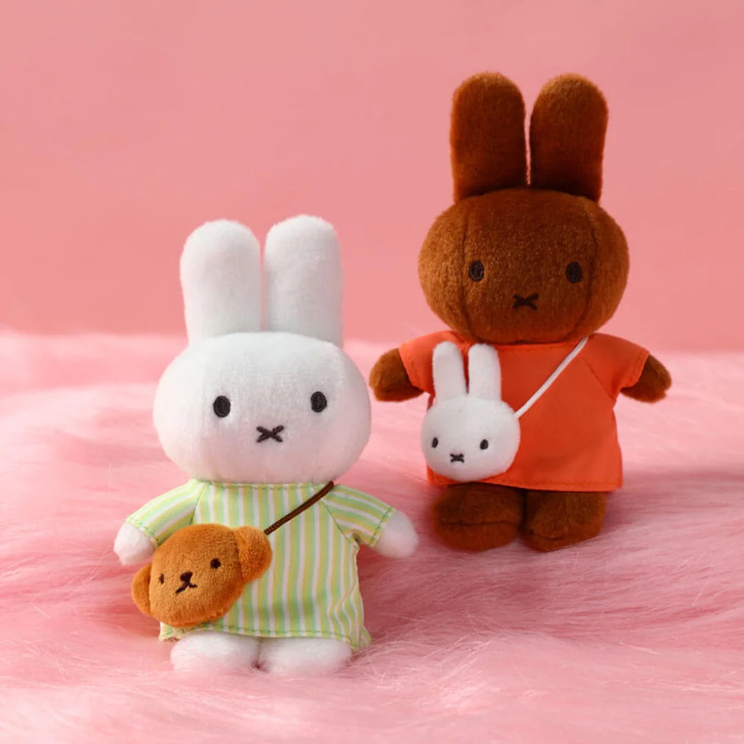 Two plush bag clips, one white and one brown. Miffy blind box variants 