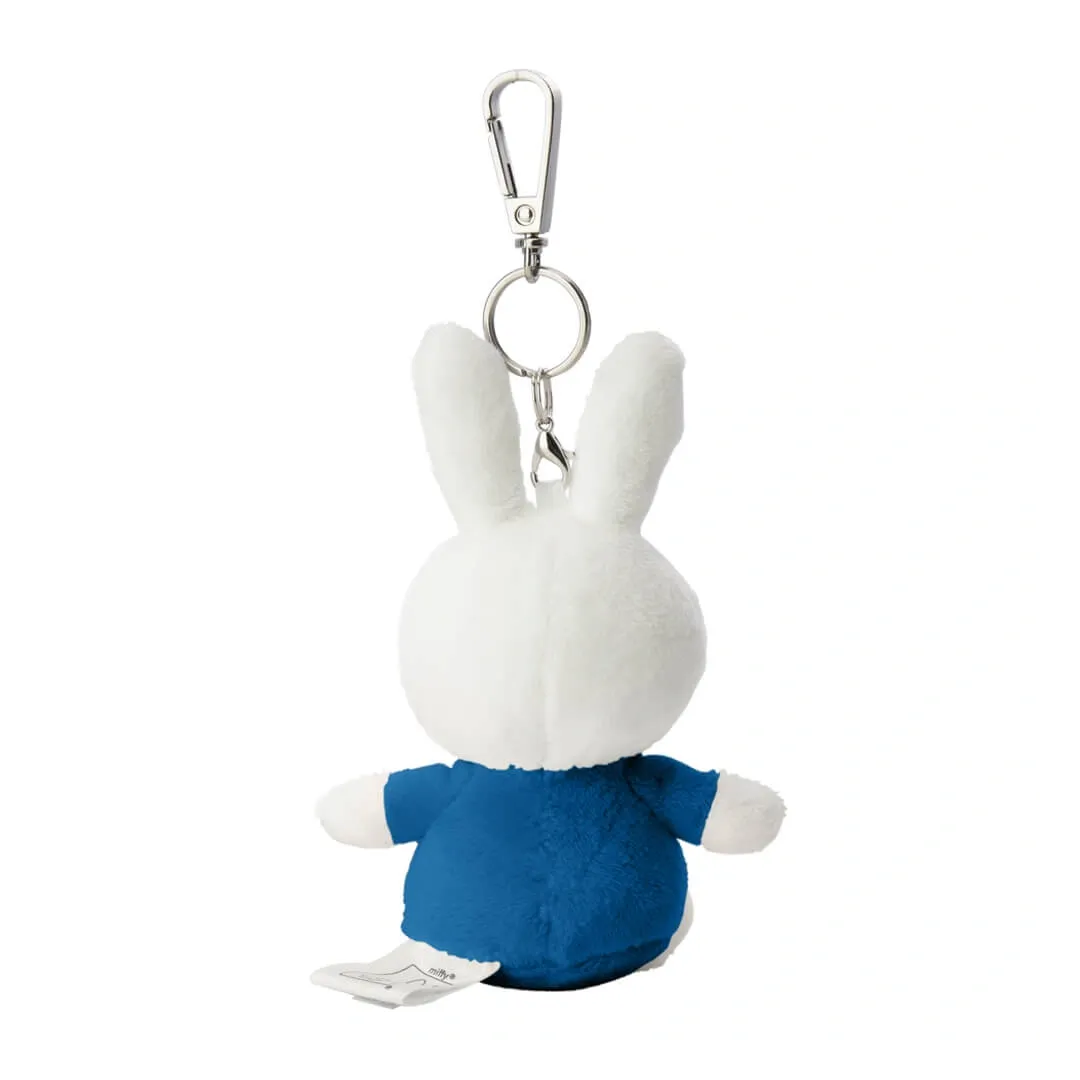 Plush keychain of a white rabbit character wearing a blue outfit on a white background