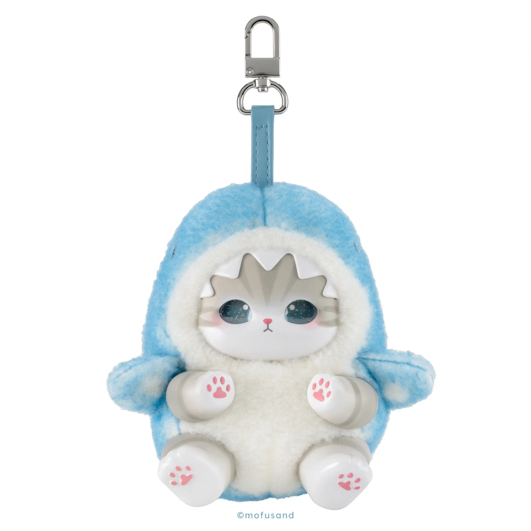 A plush keychain or bag charm shaped like a cute cartoon cat in a blue shark suit, with a silver metal clasp at the top, on a plain white background.