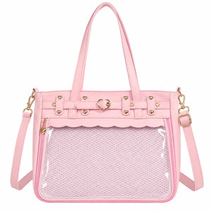 A pink ita bag with a clear mesh front pocket, gold-tone hardware, and a matching shoulder strap, shown on a plain white background.