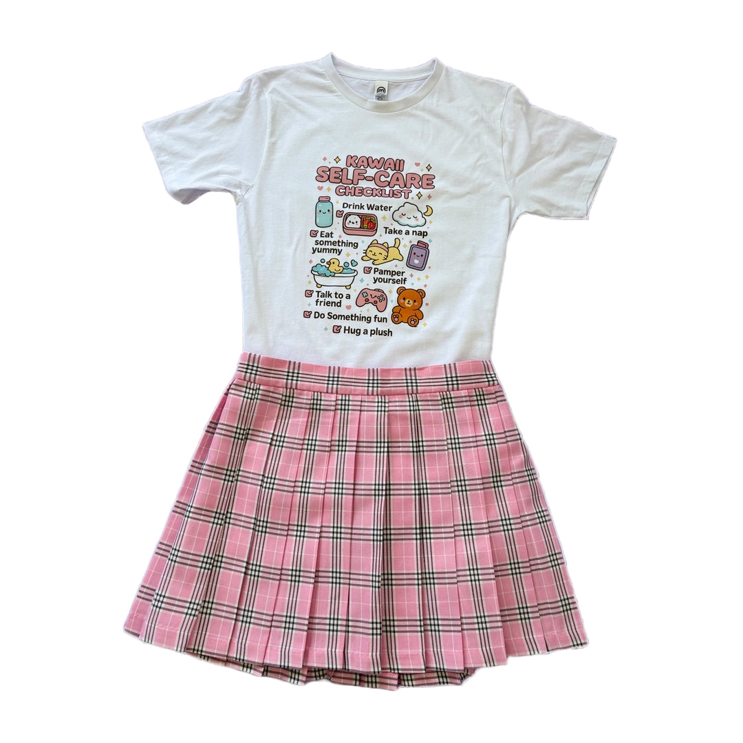 Kawaii outfit. white graphic Kawaii self care tee and pink pleated skirt 