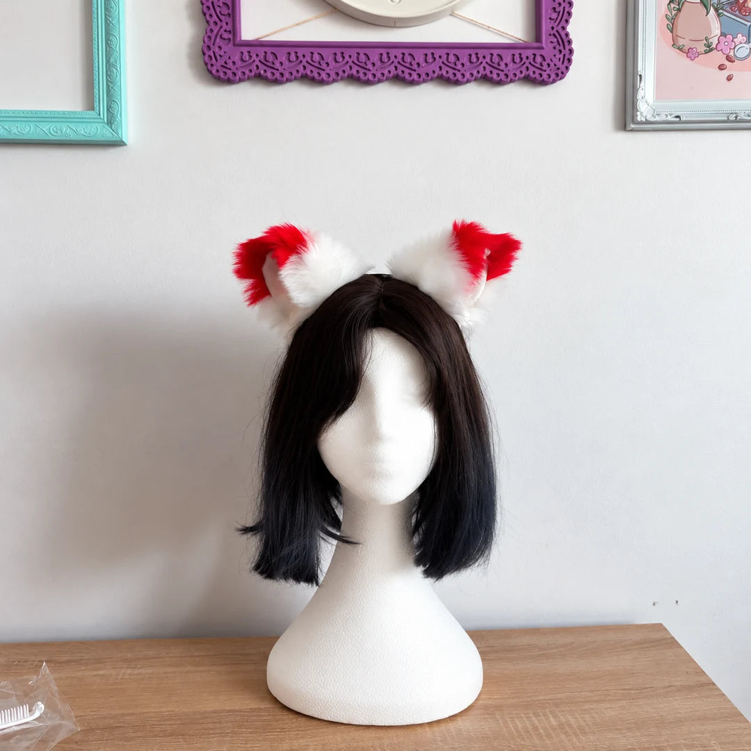 White cat ears with red tips placed on head mannequin 