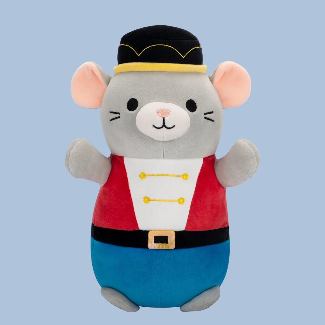 Plush toy mouse in a costume on a light blue background