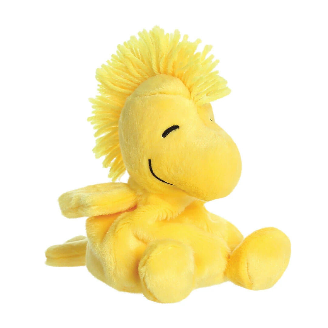 Yellow plush Woodstock from Snoopy bird toy on a white background