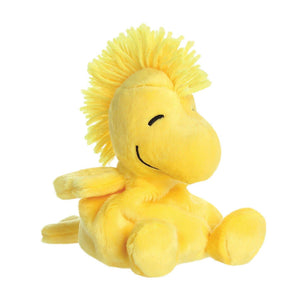 Yellow plush Woodstock from Snoopy bird toy on a white background